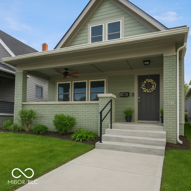 1709 Fletcher Ave, Indianapolis, IN 46203 - view of front of property with brick siding, covered porch, ceiling fan, and a front yard