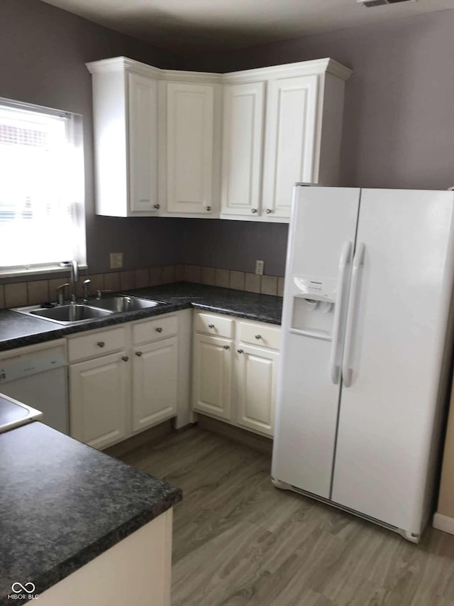 55 W Fall Creek Parkway S Drive, Indianapolis, IN 46208 - kitchen featuring white appliances, a sink, light wood-style floors, and white cabinets