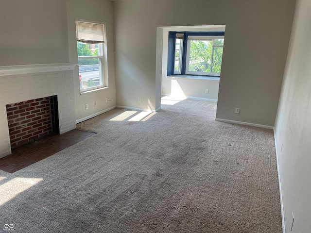 55 W Fall Creek Parkway S Drive, Indianapolis, IN 46208 - unfurnished living room featuring carpet floors, plenty of natural light, and baseboards