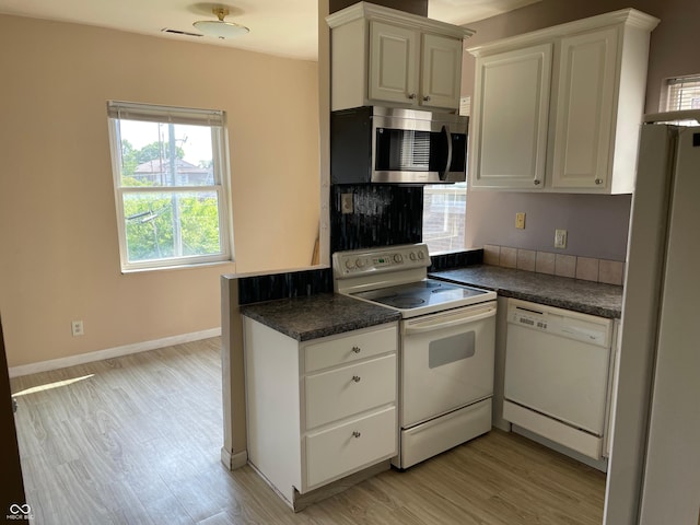 55 W Fall Creek Parkway S Drive, Indianapolis, IN 46208 - kitchen with white appliances, dark countertops, light wood-type flooring, and white cabinets