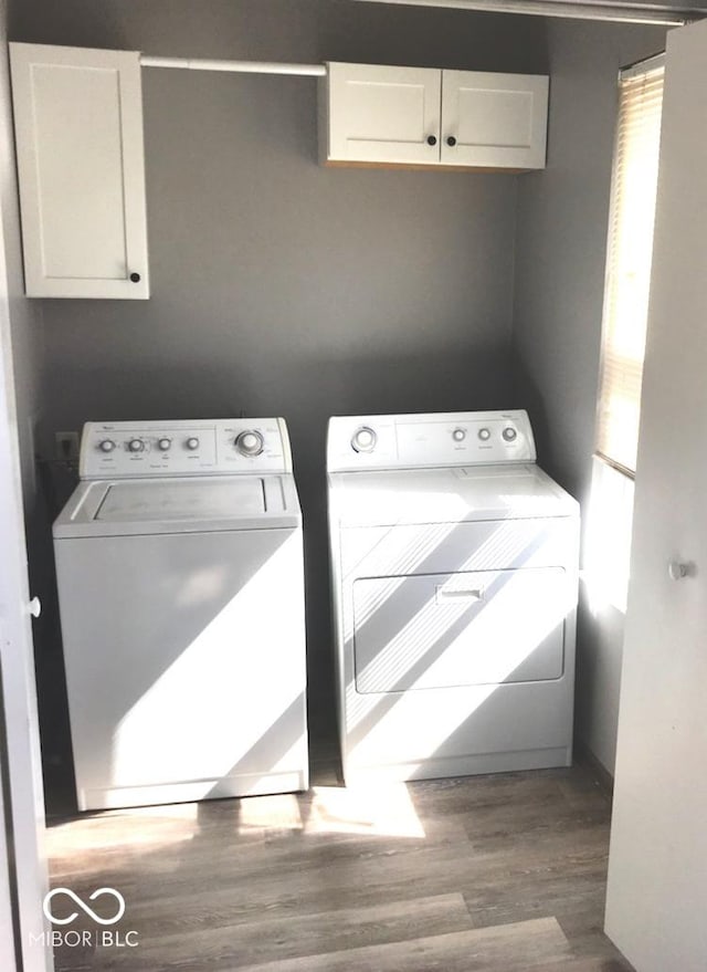 55 W Fall Creek Parkway S Drive, Indianapolis, IN 46208 - laundry room featuring cabinet space, washer and clothes dryer, and wood finished floors