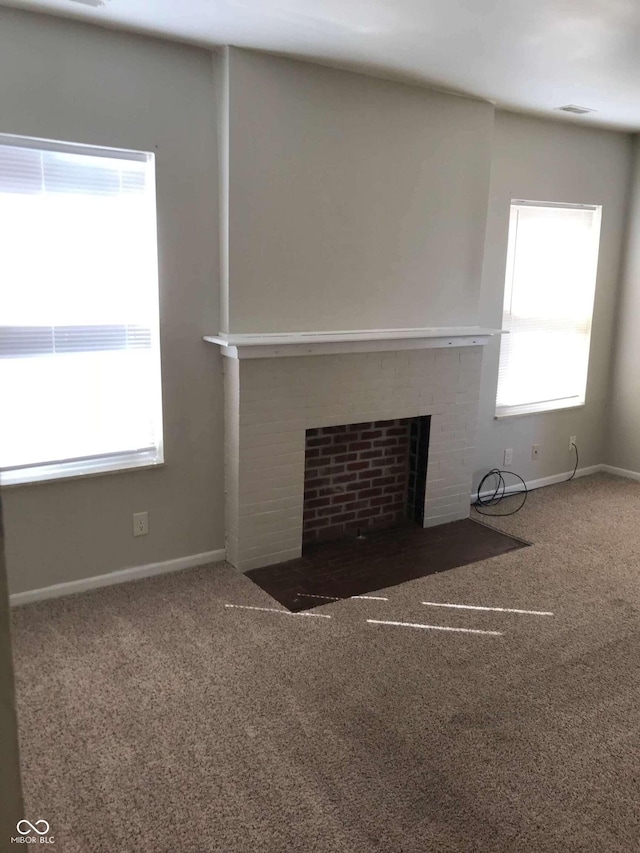 55 W Fall Creek Parkway S Drive, Indianapolis, IN 46208 - unfurnished living room with carpet, a tiled fireplace, and baseboards