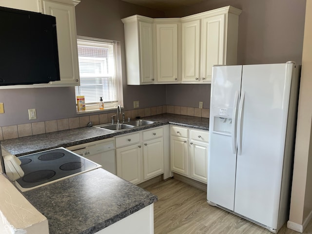55 W Fall Creek Parkway S Drive, Indianapolis, IN 46208 - kitchen featuring white appliances, a sink, dark countertops, light wood-style floors, and white cabinets