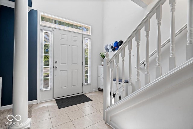 11509 Reagan Dr, Fishers, IN 46038 - tiled foyer featuring baseboards, a towering ceiling, and stairway