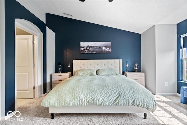 11509 Reagan Dr, Fishers, IN 46038 - carpeted bedroom featuring lofted ceiling, arched walkways, and a ceiling fan