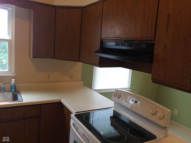 59 W Fall Creek Parkway S Drive, Indianapolis, IN 46208 - kitchen featuring white range with electric stovetop, exhaust hood, a sink, and light countertops
