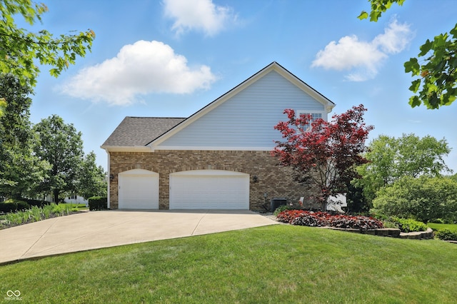 16802 Oak Manor Dr, Westfield, IN 46074 - view of property exterior featuring brick siding, a yard, driveway, an attached garage, and central AC unit