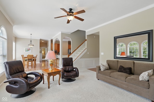 16802 Oak Manor Dr, Westfield, IN 46074 - carpeted living area featuring ornamental molding, stairs, a ceiling fan, a wainscoted wall, and a decorative wall