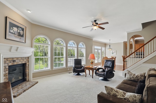 16802 Oak Manor Dr, Westfield, IN 46074 - carpeted living room featuring a brick fireplace, crown molding, ceiling fan, plenty of natural light, and baseboards