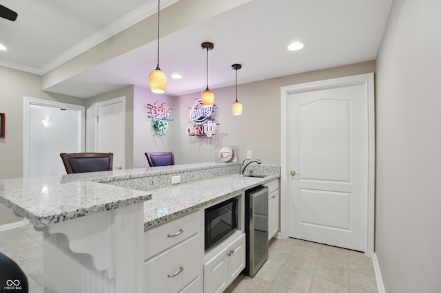16802 Oak Manor Dr, Westfield, IN 46074 - kitchen featuring black microwave, a peninsula, wine cooler, recessed lighting, and ornamental molding