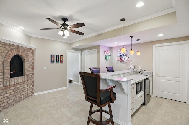 16802 Oak Manor Dr, Westfield, IN 46074 - kitchen with a peninsula, a breakfast bar area, recessed lighting, white cabinetry, and decorative light fixtures