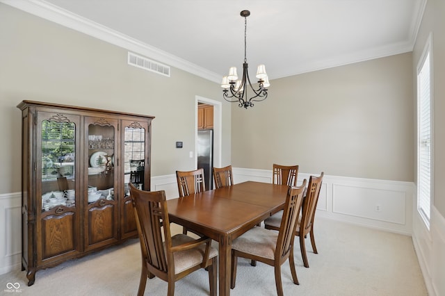 16802 Oak Manor Dr, Westfield, IN 46074 - dining space featuring a chandelier, a wainscoted wall, ornamental molding, light carpet, and a decorative wall