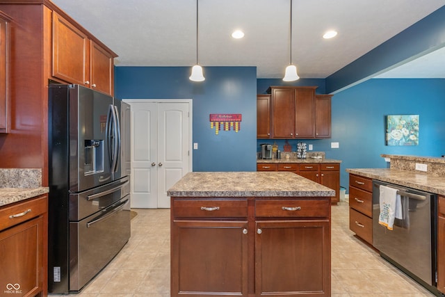 1696 Woodfield Dr, Greenwood, IN 46143 - kitchen featuring appliances with stainless steel finishes, decorative light fixtures, brown cabinetry, and light tile patterned floors