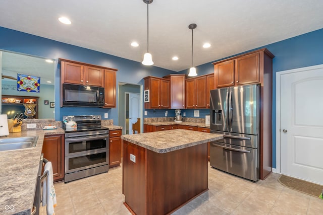 1696 Woodfield Dr, Greenwood, IN 46143 - kitchen with stainless steel appliances, a center island, hanging light fixtures, and light countertops