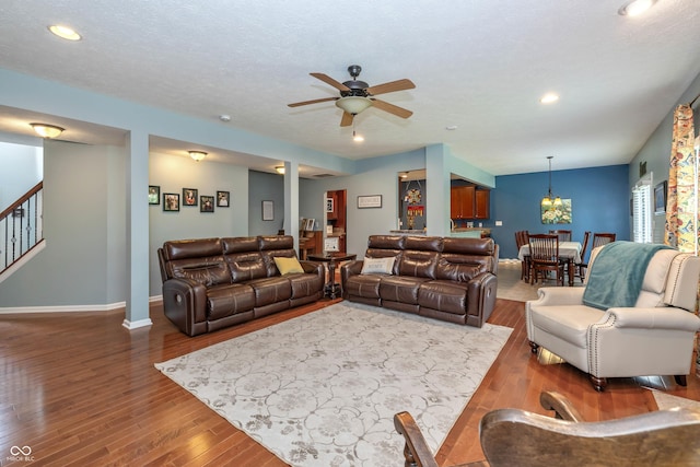 1696 Woodfield Dr, Greenwood, IN 46143 - living room with a ceiling fan, wood finished floors, baseboards, recessed lighting, and stairway