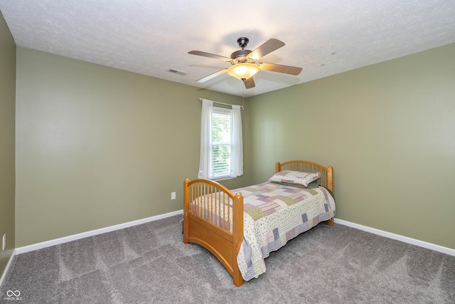 1696 Woodfield Dr, Greenwood, IN 46143 - bedroom featuring carpet flooring, baseboards, a ceiling fan, and a textured ceiling