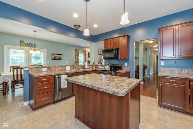 1696 Woodfield Dr, Greenwood, IN 46143 - kitchen with appliances with stainless steel finishes, a peninsula, a sink, a kitchen island, and decorative light fixtures
