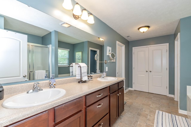 1696 Woodfield Dr, Greenwood, IN 46143 - full bath featuring baseboards, a shower stall, and double vanity