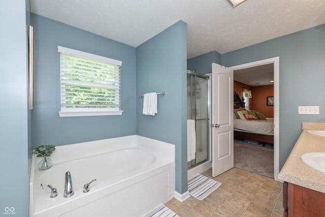 1696 Woodfield Dr, Greenwood, IN 46143 - ensuite bathroom with a garden tub, a shower stall, double vanity, and a textured ceiling