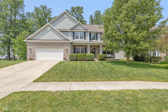 1696 Woodfield Dr, Greenwood, IN 46143 - view of front of home with concrete driveway, a front lawn, covered porch, and brick siding