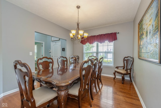 1696 Woodfield Dr, Greenwood, IN 46143 - dining room with hardwood / wood-style flooring, a chandelier, and baseboards