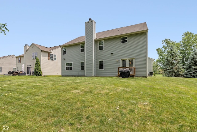 1696 Woodfield Dr, Greenwood, IN 46143 - back of property with a yard, a chimney, and central air condition unit