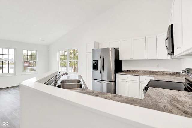 3371 Weathered Rock Cir, Kokomo, IN 46902 - kitchen featuring appliances with stainless steel finishes, a sink, vaulted ceiling, white cabinets, and wood finished floors