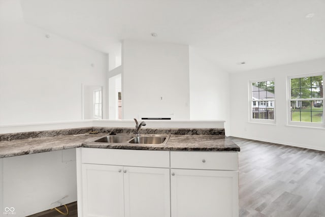 3371 Weathered Rock Cir, Kokomo, IN 46902 - kitchen featuring a sink, lofted ceiling, wood finished floors, and white cabinetry