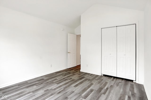 3371 Weathered Rock Cir, Kokomo, IN 46902 - unfurnished bedroom featuring wood finished floors, lofted ceiling, a closet, and baseboards