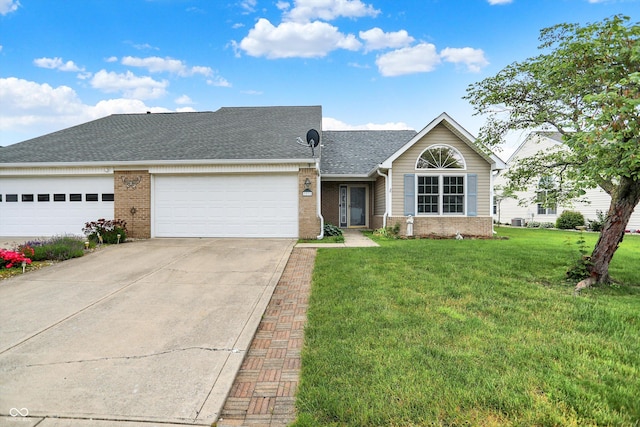 3371 Weathered Rock Cir, Kokomo, IN 46902 - view of front of house with brick siding, an attached garage, concrete driveway, a front lawn, and roof with shingles