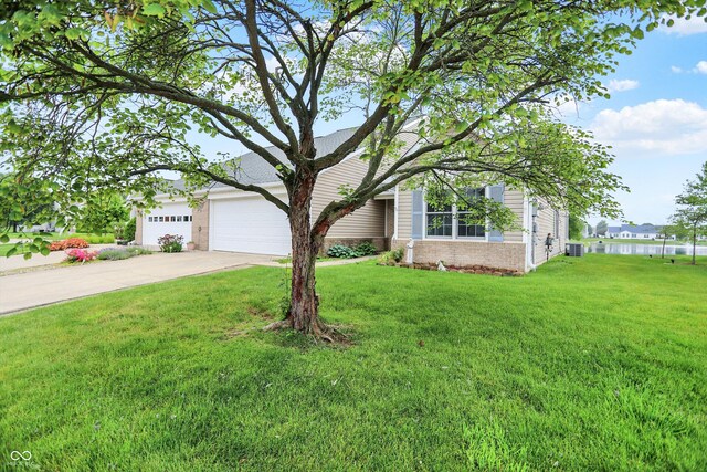 3371 Weathered Rock Cir, Kokomo, IN 46902 - obstructed view of property featuring brick siding, driveway, a front lawn, and an attached garage