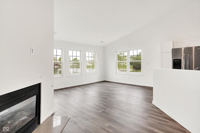 3371 Weathered Rock Cir, Kokomo, IN 46902 - unfurnished living room with vaulted ceiling, dark wood finished floors, a premium fireplace, and baseboards