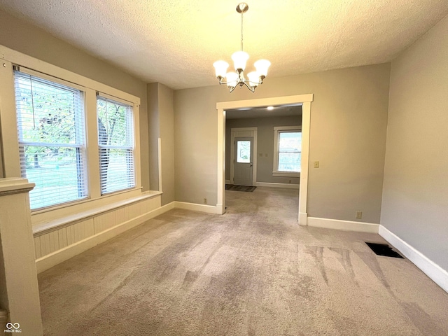 38 N Irvington Ave, Indianapolis, IN 46219 - unfurnished dining area featuring a textured ceiling, a chandelier, and light carpet