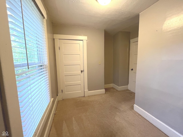 38 N Irvington Ave, Indianapolis, IN 46219 - hallway featuring light colored carpet and a textured ceiling