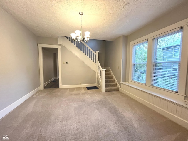 38 N Irvington Ave, Indianapolis, IN 46219 - unfurnished living room featuring a textured ceiling, a chandelier, stairs, and carpet