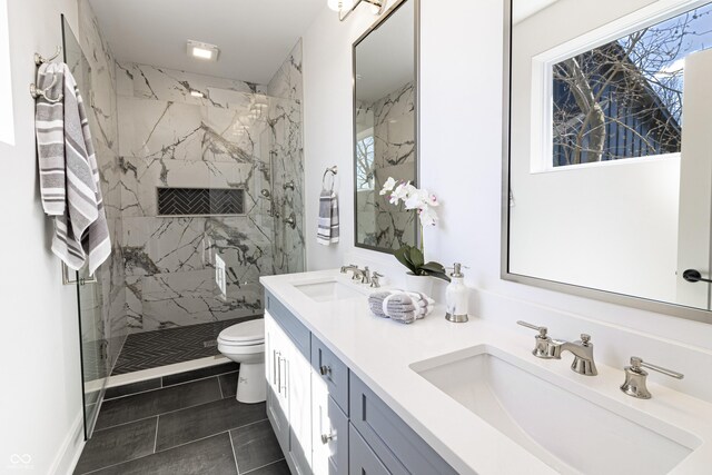 2051 Columbia Ave, Indianapolis, IN 46202 - bathroom featuring toilet, double vanity, a marble finish shower, and tile patterned floors