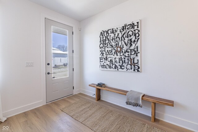 2051 Columbia Ave, Indianapolis, IN 46202 - doorway to outside featuring wood finished floors and baseboards
