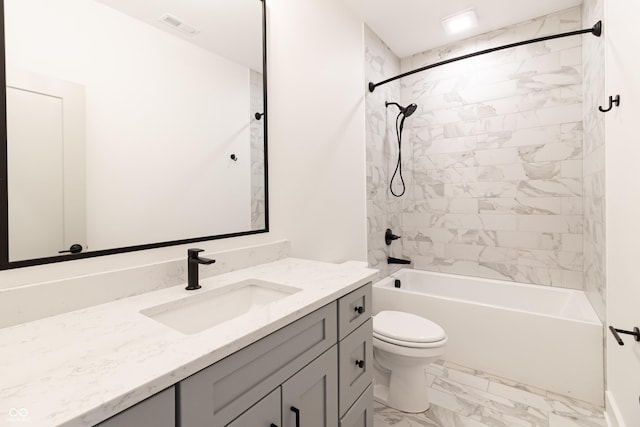 2051 Columbia Ave, Indianapolis, IN 46202 - full bath with marble look tiles, vanity, toilet, and shower / bathtub combination