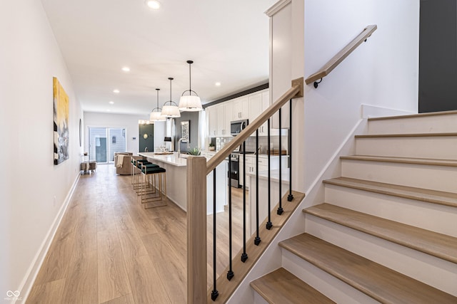 2051 Columbia Ave, Indianapolis, IN 46202 - staircase with wood finished floors, recessed lighting, and baseboards
