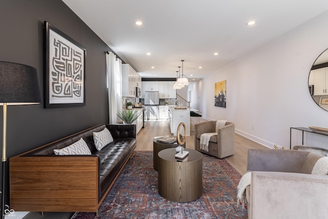 2051 Columbia Ave, Indianapolis, IN 46202 - living room with light wood-style floors, recessed lighting, stairs, and baseboards