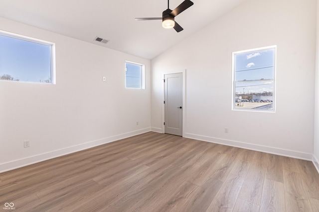 2053 Columbia Ave, Indianapolis, IN 46202 - empty room with a ceiling fan, light wood finished floors, baseboards, and high vaulted ceiling