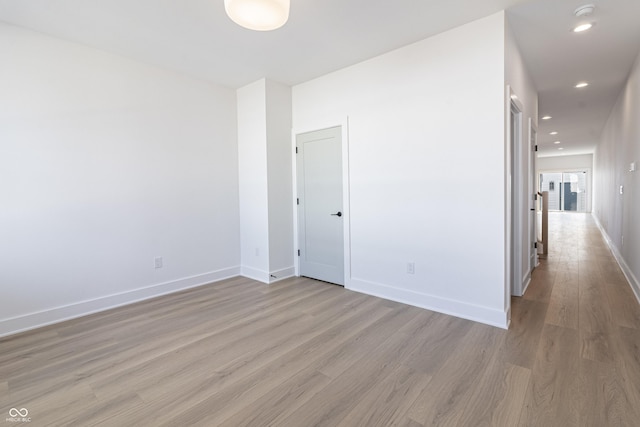 2053 Columbia Ave, Indianapolis, IN 46202 - unfurnished room with light wood finished floors, baseboards, recessed lighting, and a smoke detector
