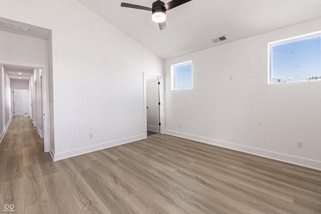 2053 Columbia Ave, Indianapolis, IN 46202 - empty room with vaulted ceiling, light wood-style flooring, ceiling fan, and baseboards