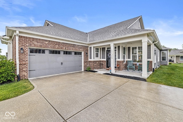 17309 Graley Pl, Westfield, IN 46074 - view of front of property with brick siding, a porch, concrete driveway, a garage, and a shingled roof