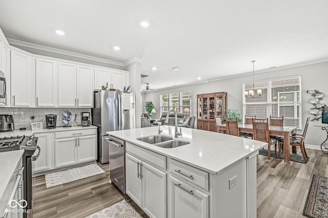 17309 Graley Pl, Westfield, IN 46074 - kitchen featuring a sink, appliances with stainless steel finishes, crown molding, a chandelier, and light countertops