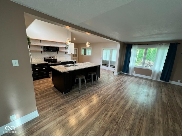 6805 Twin Brooks Dr, Indianapolis, IN 46227 - kitchen with black microwave, stainless steel range with electric cooktop, dark wood-style floors, and dark cabinetry