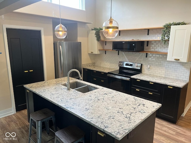 6805 Twin Brooks Dr, Indianapolis, IN 46227 - kitchen with stainless steel appliances, open shelves, light wood-type flooring, white cabinets, and backsplash
