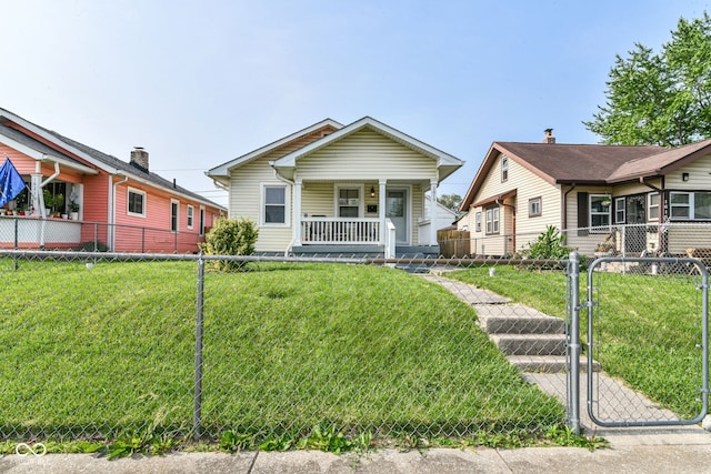 1619 E Bradbury Ave, Indianapolis, IN 46203 - shotgun-style home with a porch and a gate