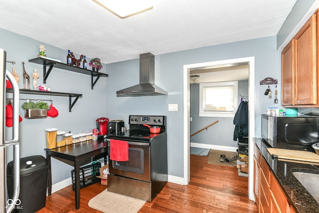 1619 E Bradbury Ave, Indianapolis, IN 46203 - kitchen with stainless steel electric range oven, wall chimney range hood, black microwave, brown cabinets, and dark wood finished floors