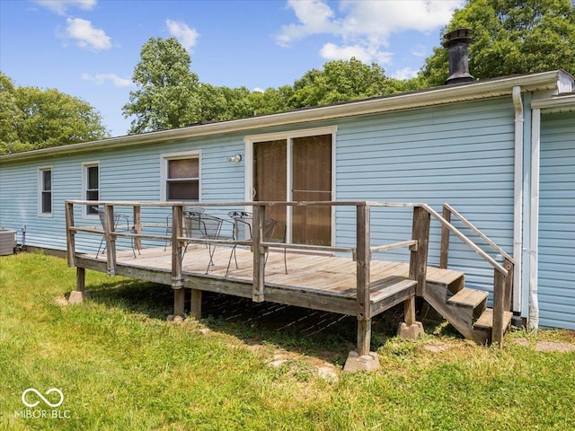 1447 NE Kutenai Trl, Greensburg, IN 47240 - rear view of property with a wooden deck, central air condition unit, and a yard